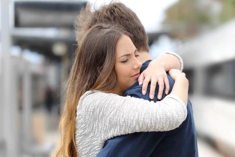 a woman wearing a white shirt comforting a man wearing a blue shirt featured image for Letting Go Letting God Heal Grief