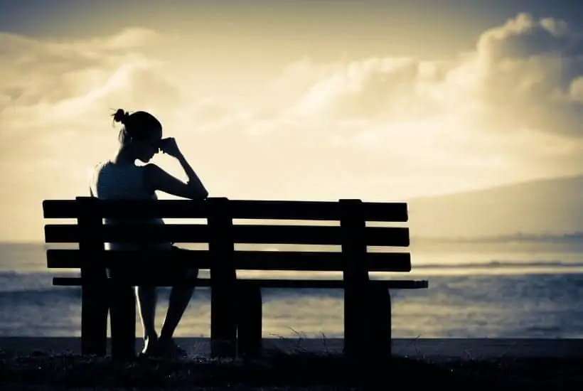 an image of a distraught woman sitting on a bench with text reading Gone But Never Forgotten Loss of a Grandchild