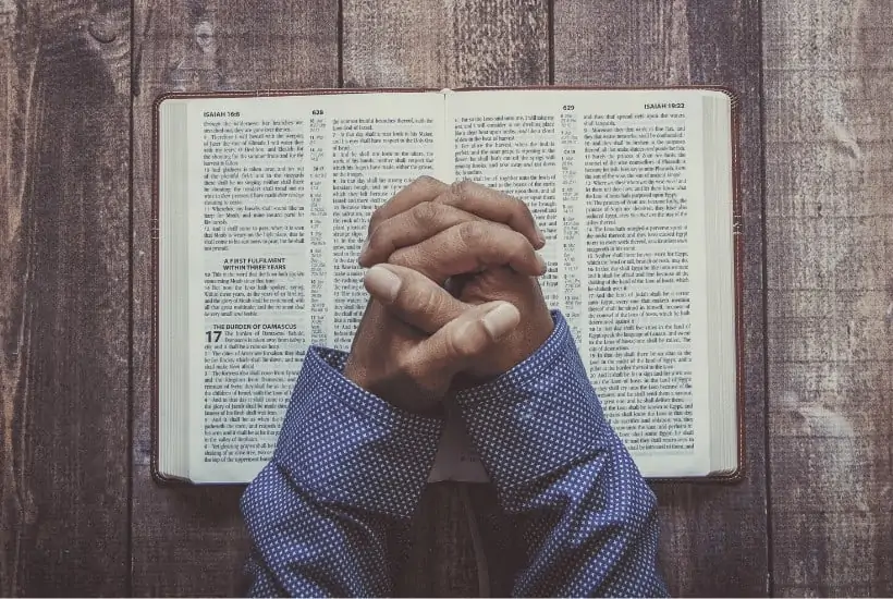 an image of an open bible on a wooden table with text reading The Eternal Importance of Sharing the Gospel