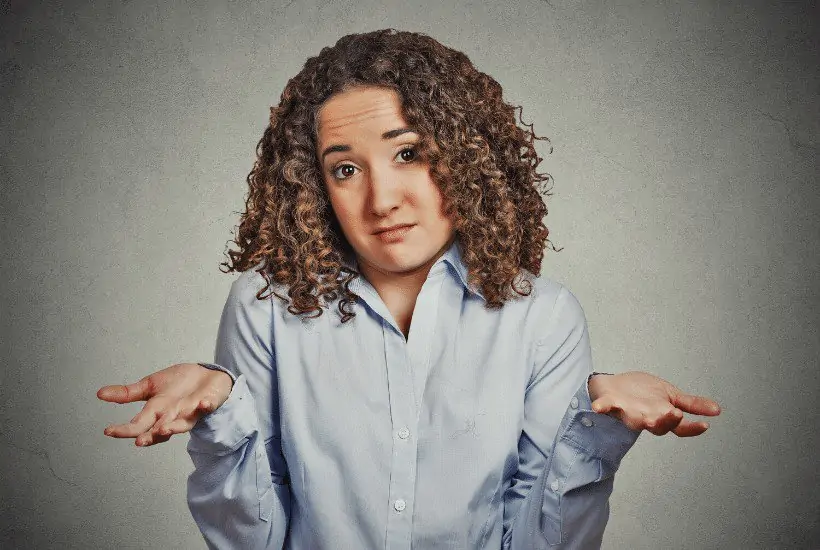 an image of a woman throwing his hands up in an i don't know gesture featured image for What To Say To An Atheist In The Best Way Peacefully